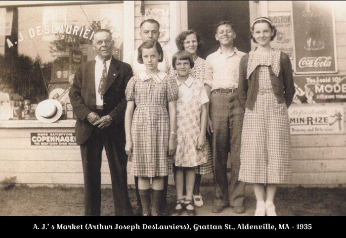 DesLauriers family group outside a storefront